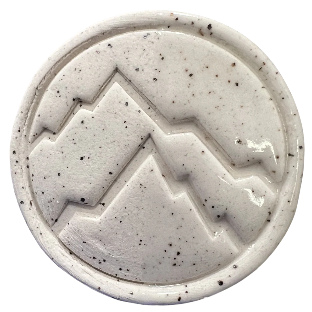 Cone 6 oxidation test tile of BMX Speckled clay showing smooth white surface with manganese speckles – Rocky Mountain Clay.