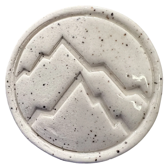 Cone 6 oxidation test tile of BMX Speckled clay showing smooth white surface with manganese speckles – Rocky Mountain Clay.